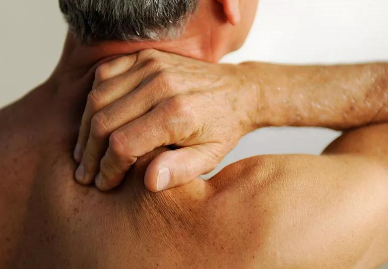 Man applying pressure point message to his neck