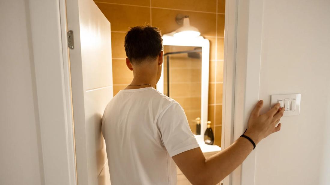 Teen walking into bathroom at home