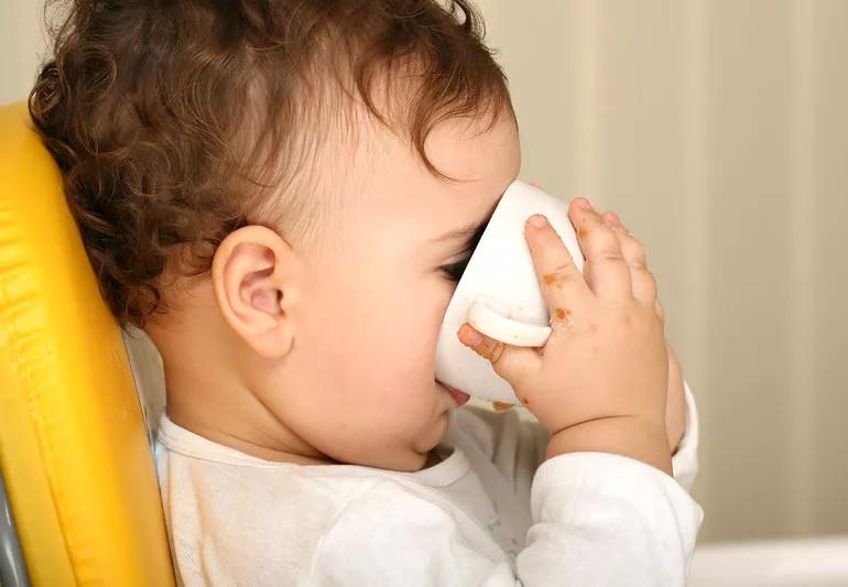 baby drinking from cup