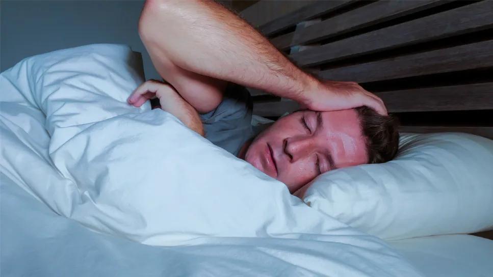 Man having fretful sleep