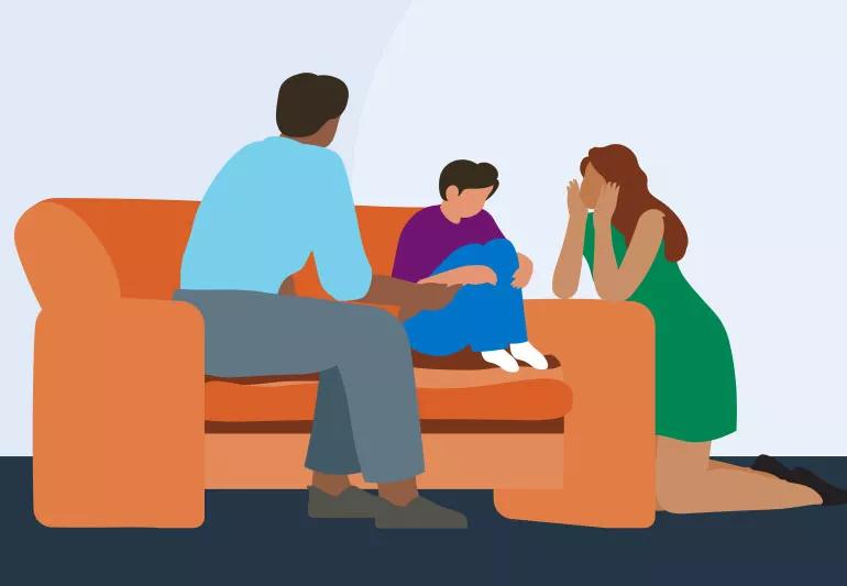 Parents have a serious talk with child in living room on couch.