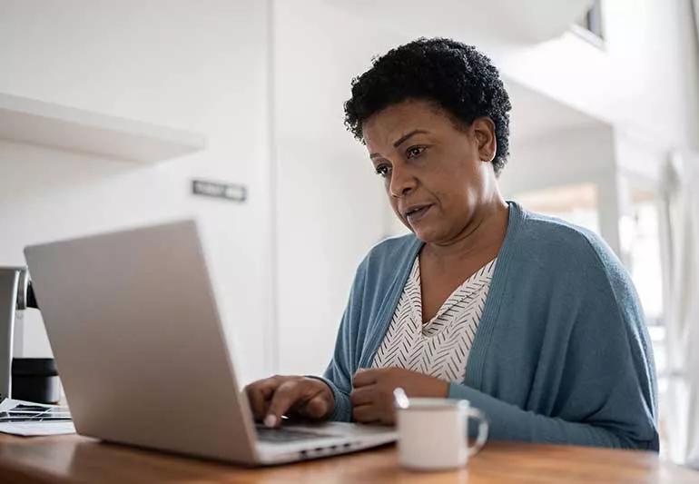 person researching on laptop