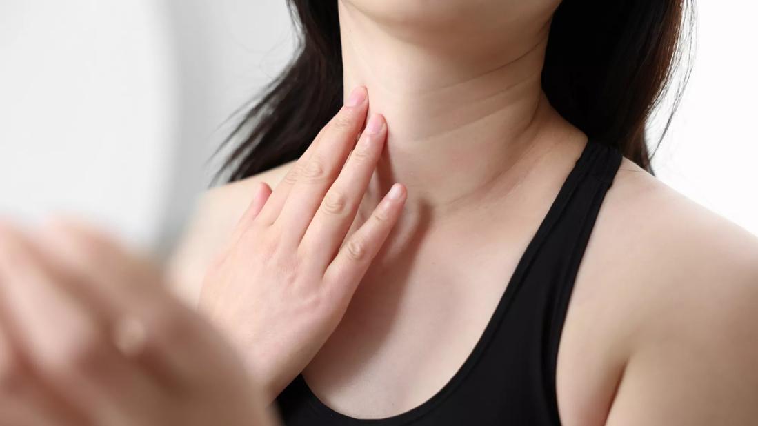 female examining neck wrinkles
