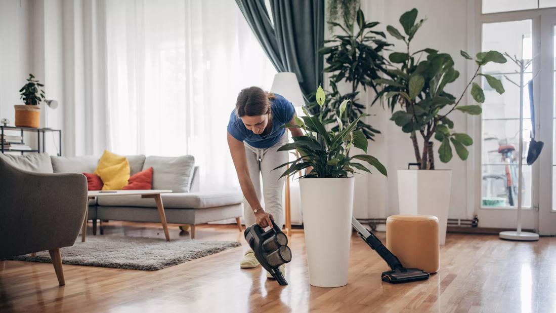 Person vacuuming around living room