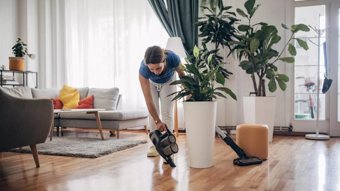 Person vacuuming around living room