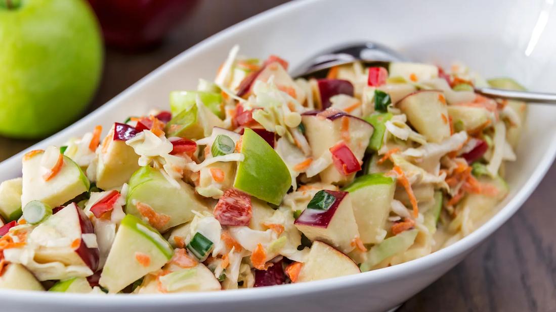 Large bowl of holiday cabbage slaw with apples and cranberries