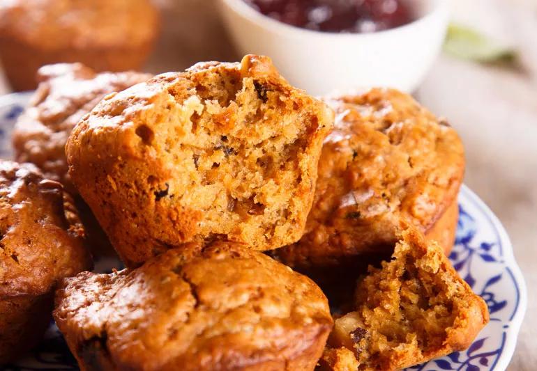 A closeup of morning glory chia seed muffins displayed in a flowered bowl.