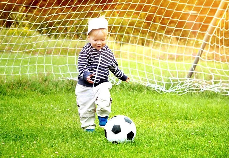 toddler running after a ball