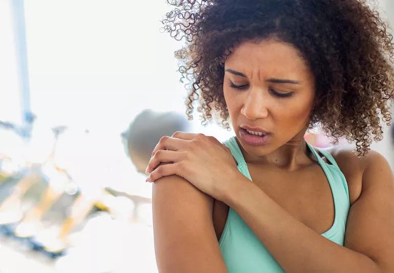 Woman a gym has shoulder pain