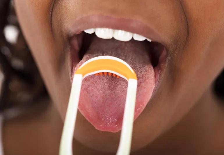 girl scraping her tongue
