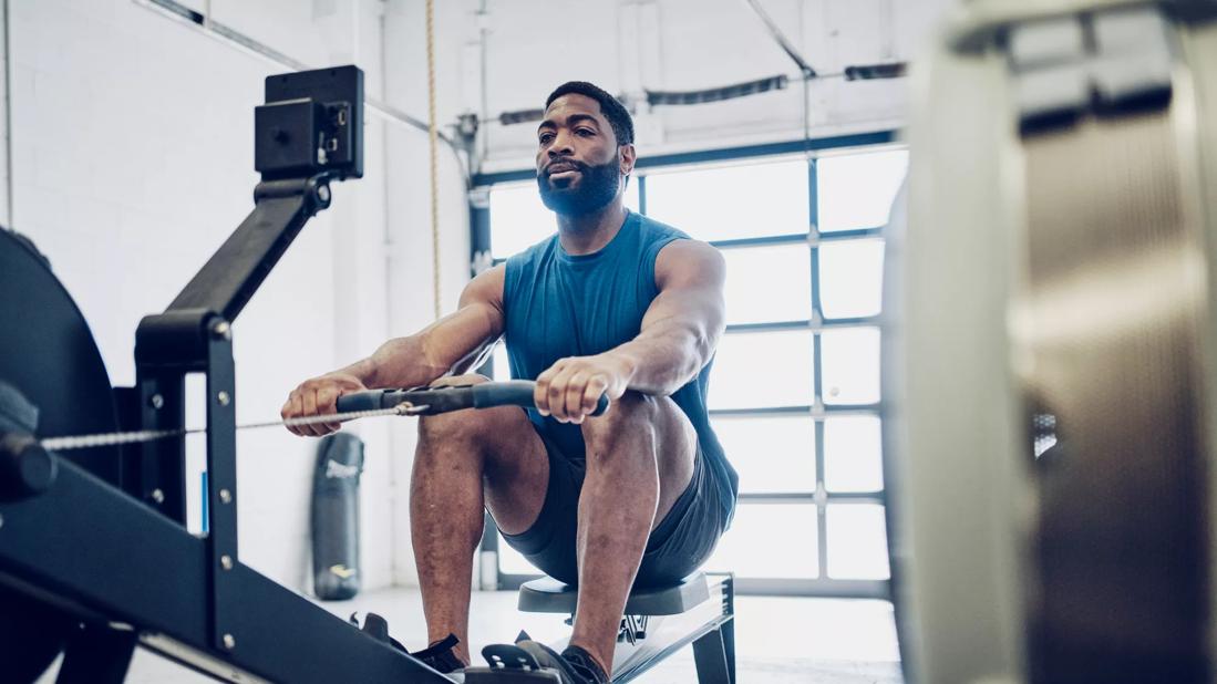 Person using rowing machine in home gym