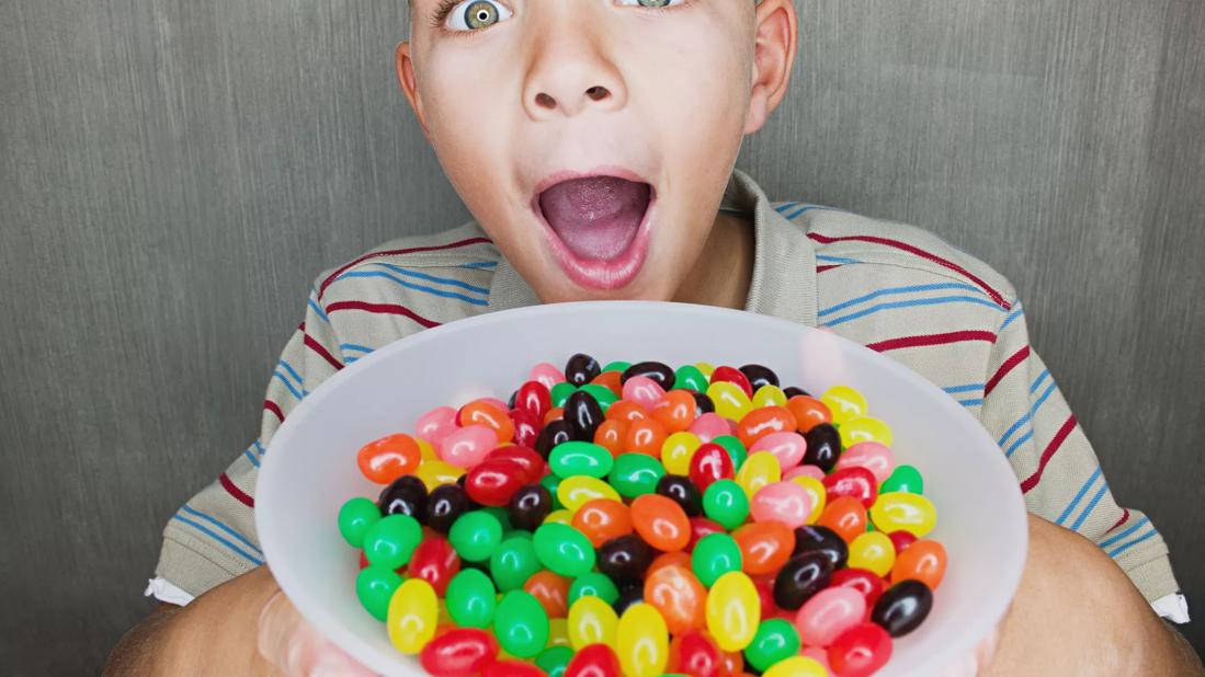 Child holding bowl of jellybeans