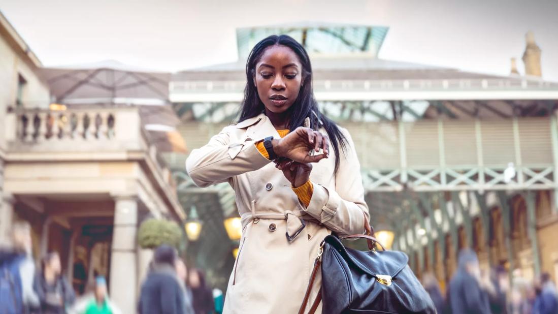 Person checking watch at a rail station