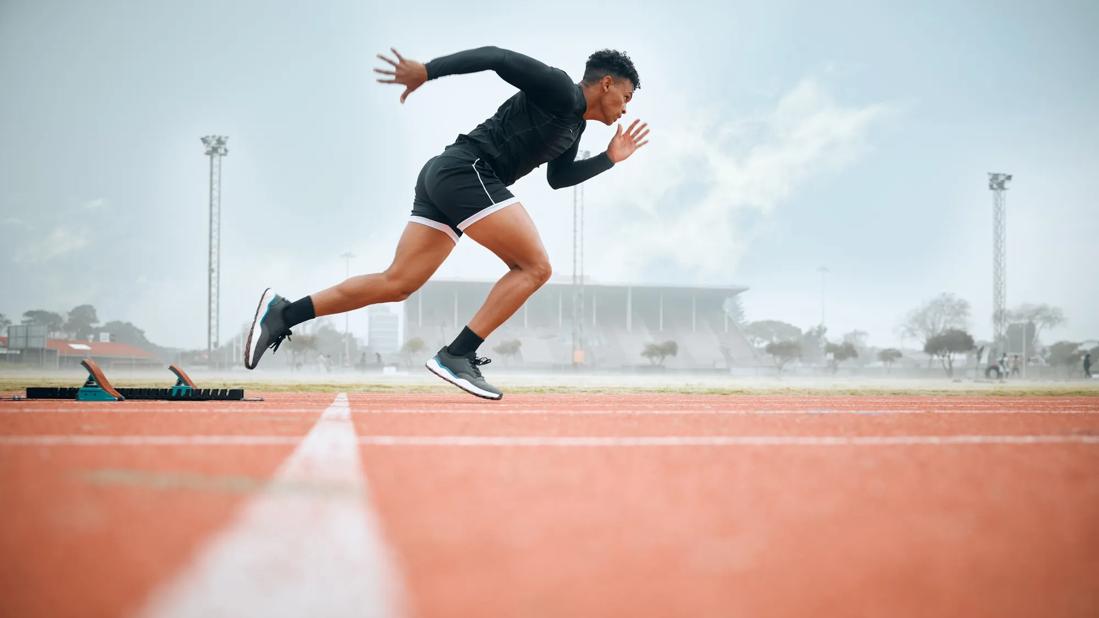 Runner sprinting from starting line on track