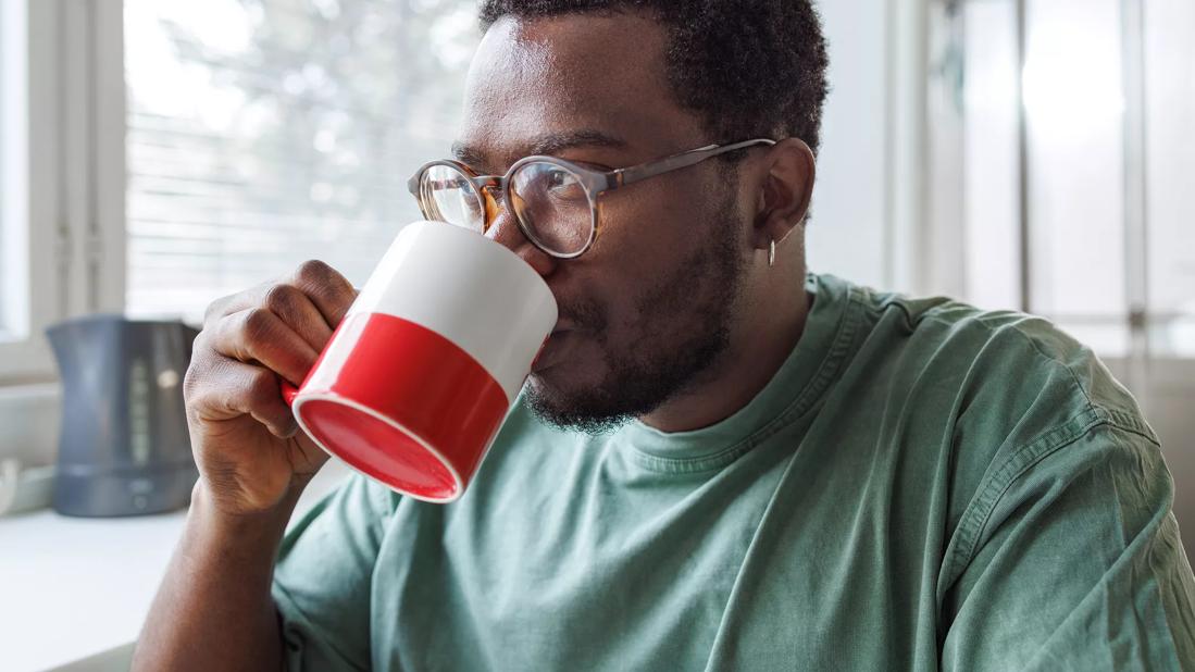 Person drinking from a coffee mug