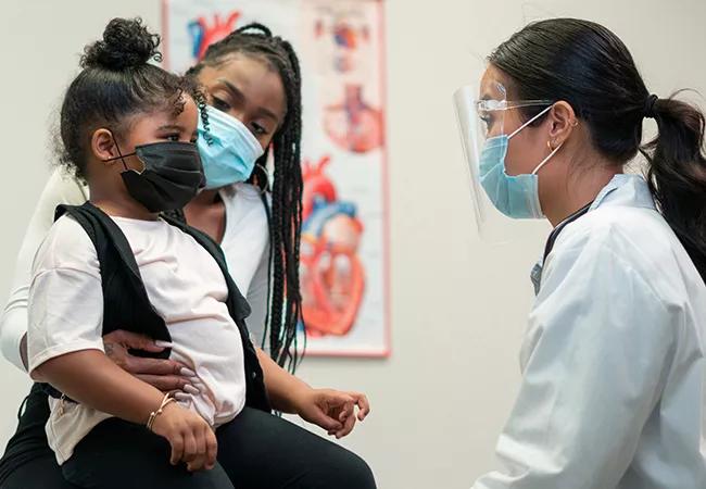 Mom and daughter visit doctor during COVID-10 pandemic