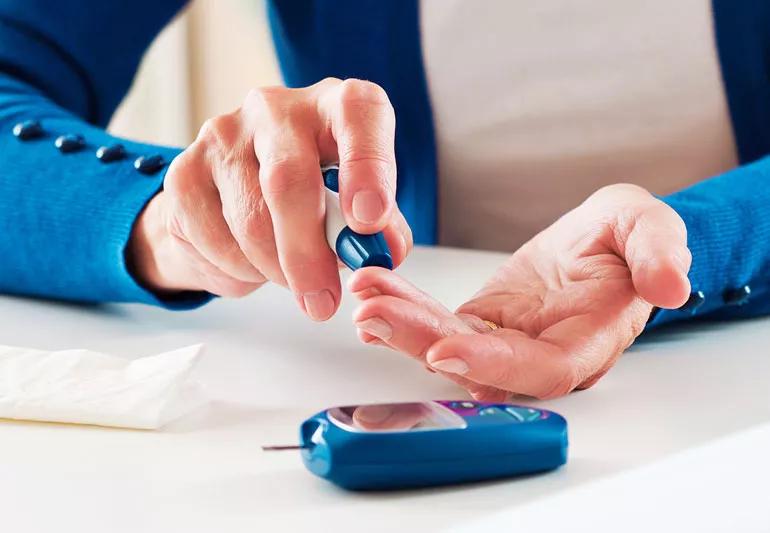 elderly woman checking her glucose reading