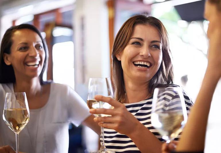 Pregnant woman out with friends at bar drinking alcohol