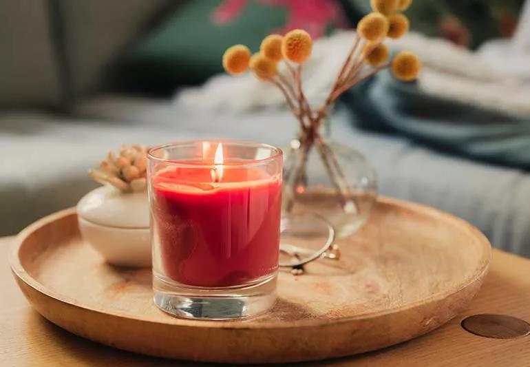 A lit candle on a table.