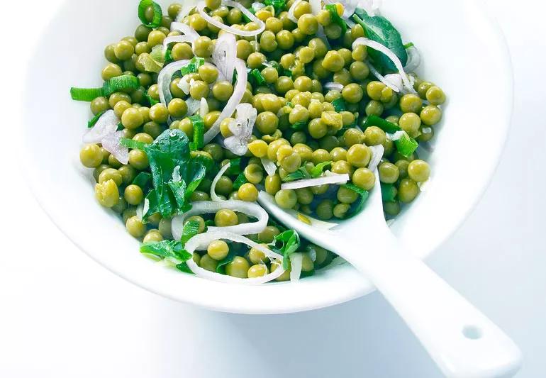 Bowl filled with peas, onions and shallots