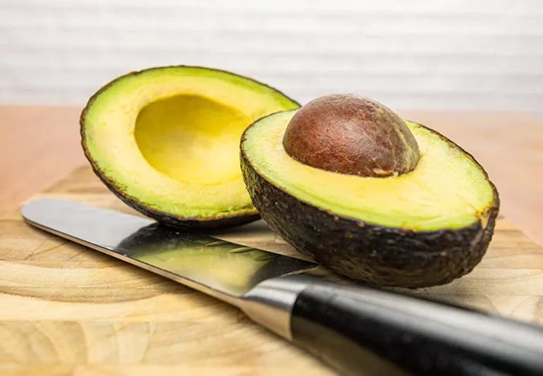 Avocado cut in half showing pit