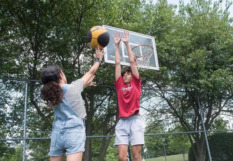 kids playing basketball in summer