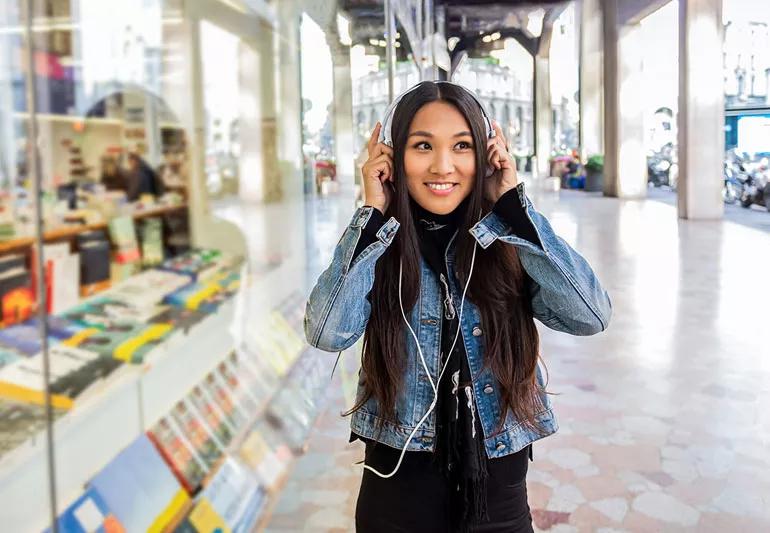 College student out shopping and listening to music