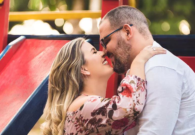 Loving couple ready to have a baby hugging outdoors.