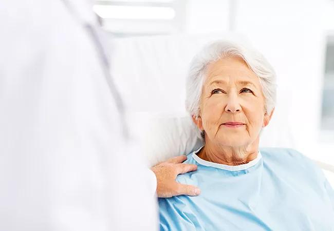 Patient Being Consoled By Doctor In Hospital Ward