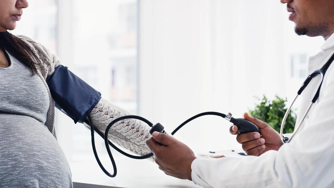 pregnant woman having blood pressure checked