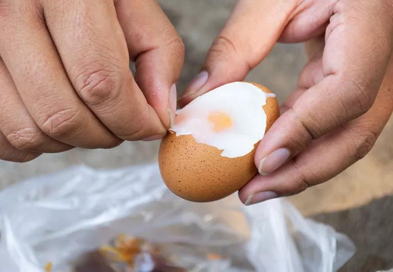 man peeling an egg cholesterol