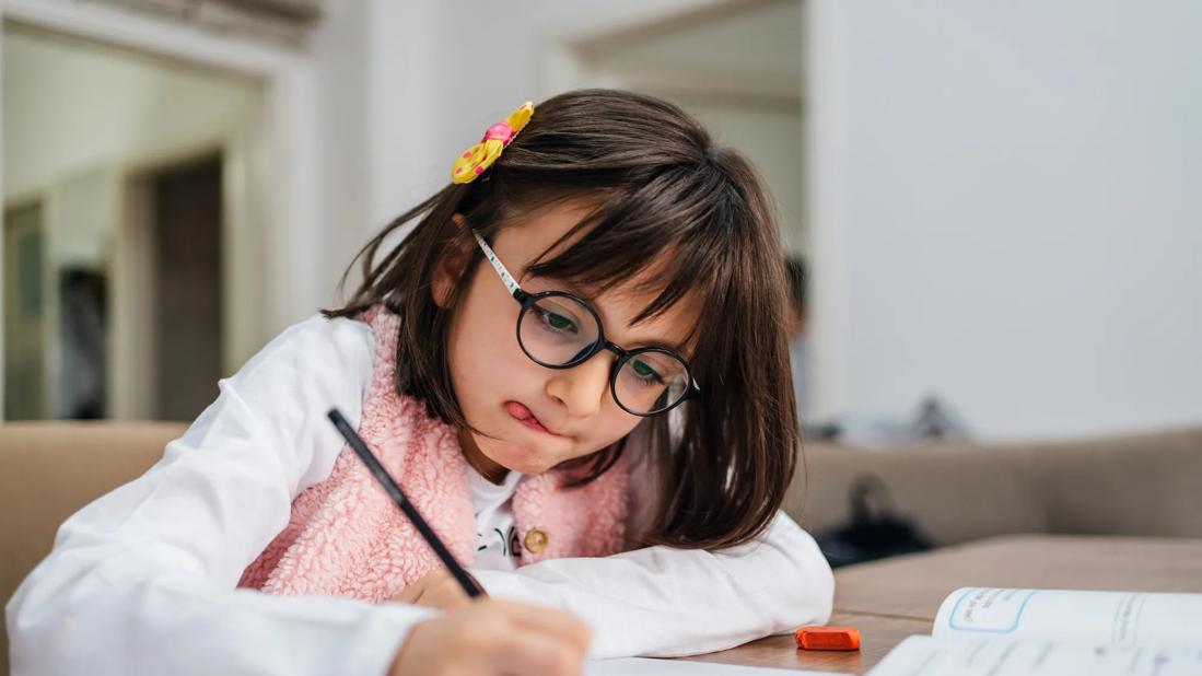 Child working on school writing assignment