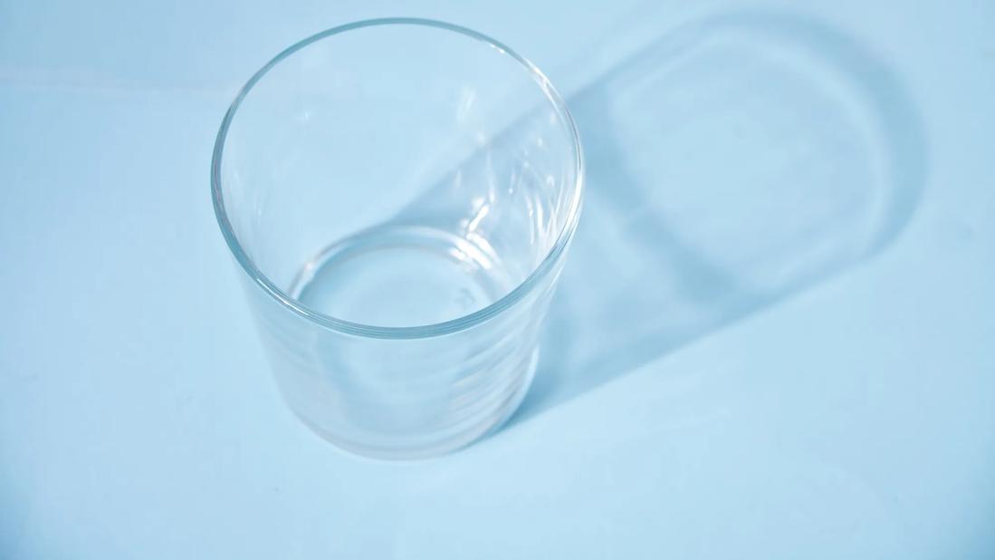 Empty glass on blue table