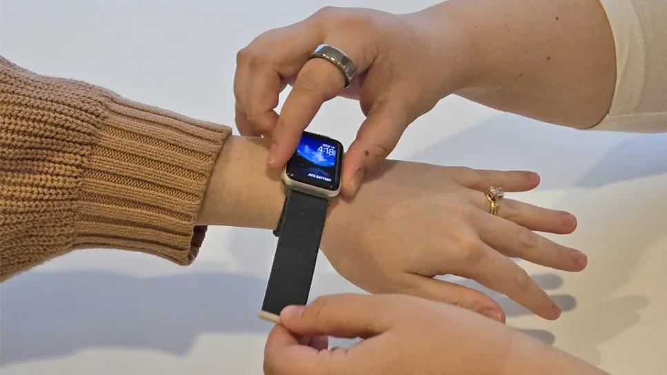 smartwatch being strapped to a woman's wrist