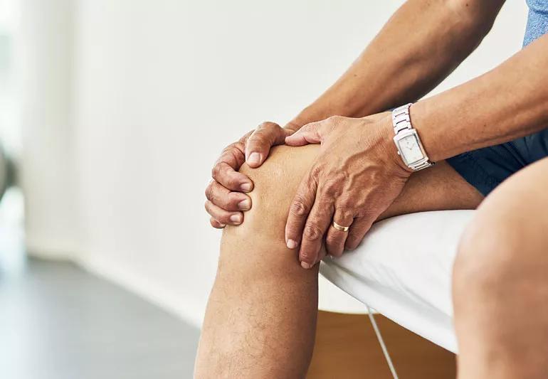 Older man with knee pain in doctor's office