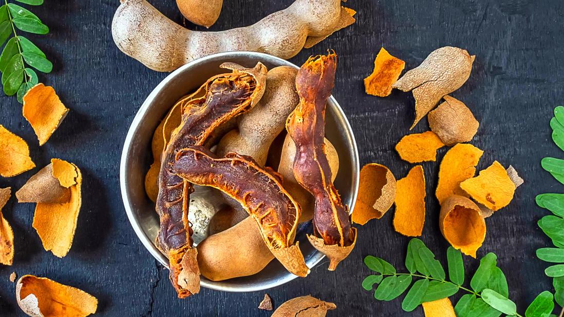 Bowl of partially peeled tamarind