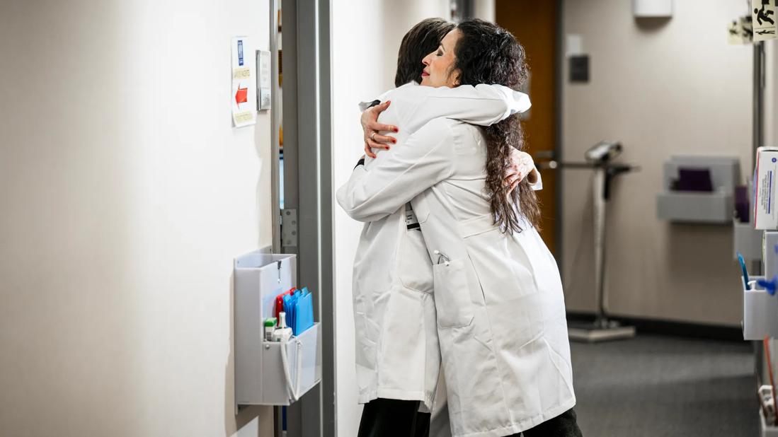 Two caregivers hugging