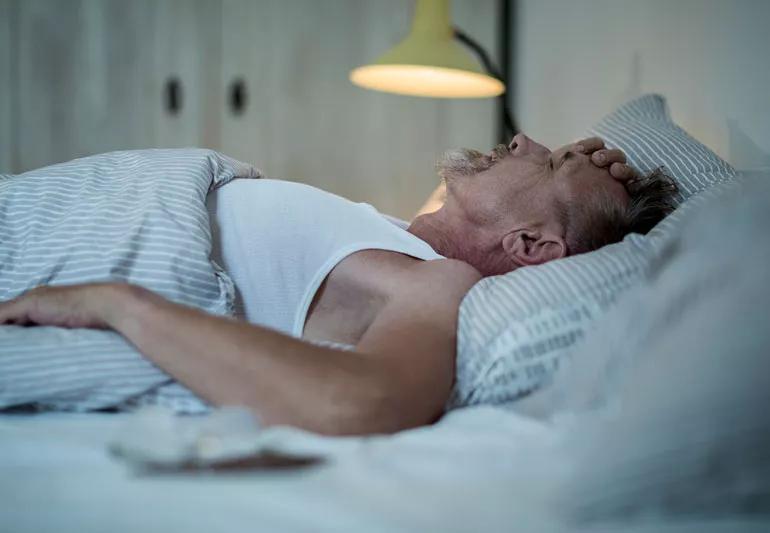 man suffering from night sweats