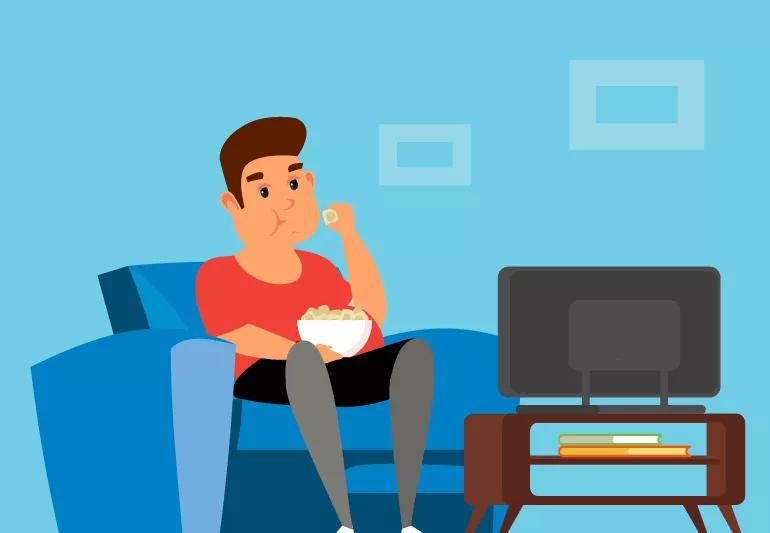 Man watching TV and having a snack