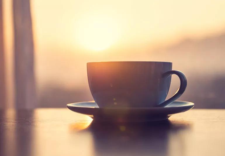 Cup of coffee at sunrise.