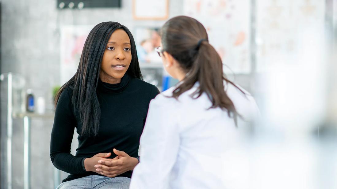 Person talking with healthcare provider in medical setting