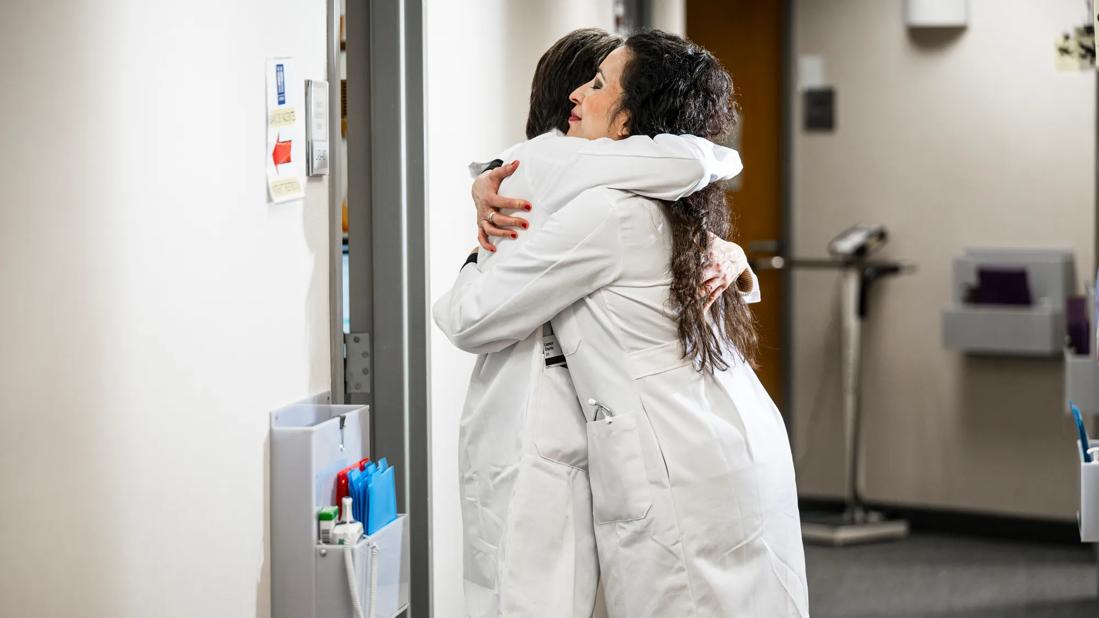 Two physicians hugging