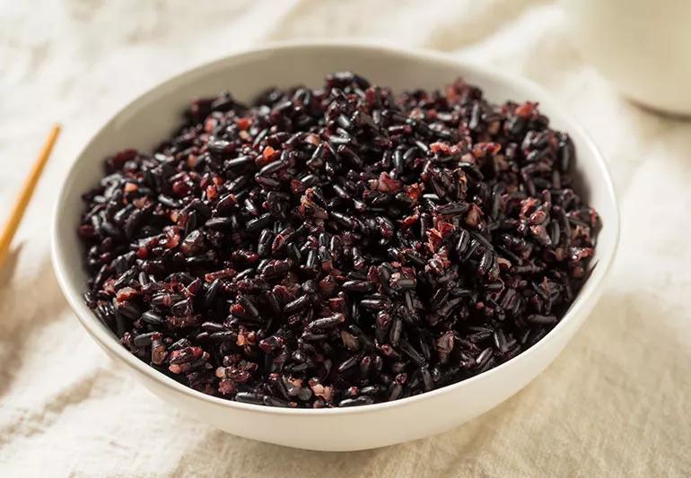 A bowl of cooked black rice, also known as "forbidden rice."