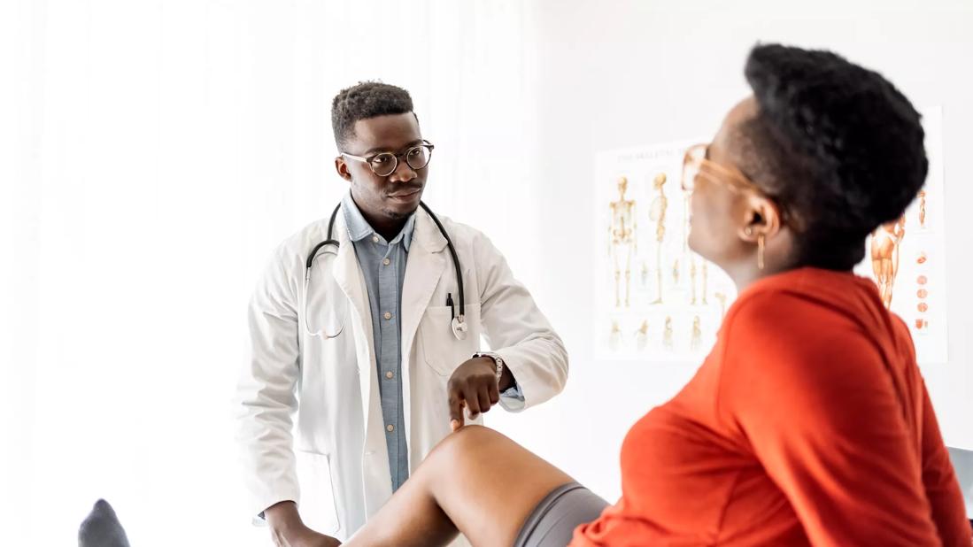 Healthcare provider checking patient's knee