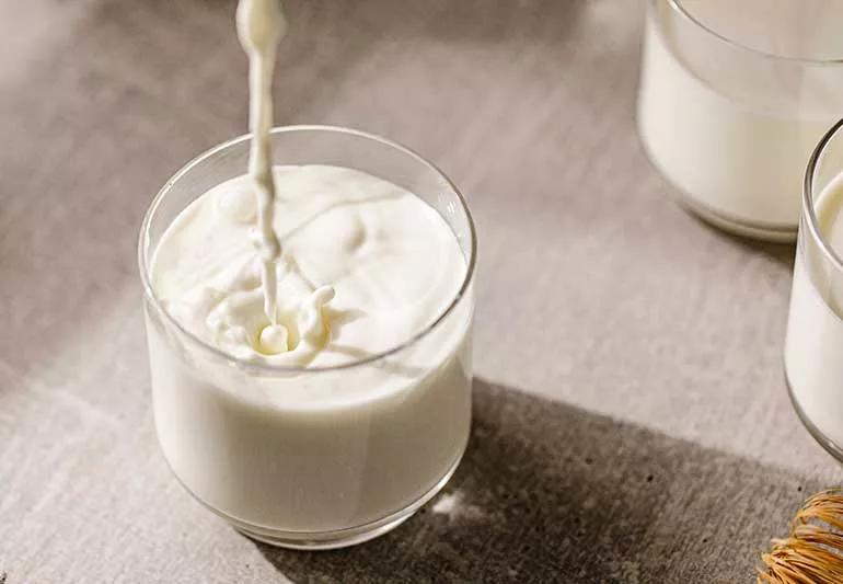 pouring dairy milk into glass