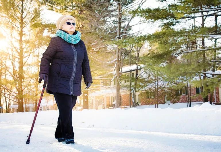 elderly woman walking outside