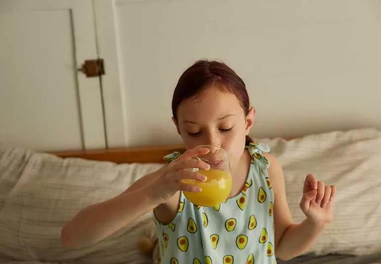 Girl drinking orange juice