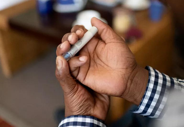 man checking glucose levels