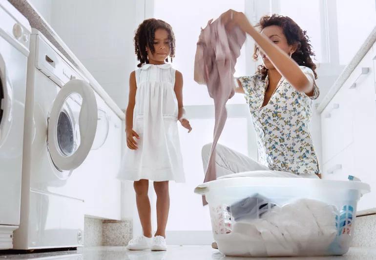 woman daughter doing laundry together