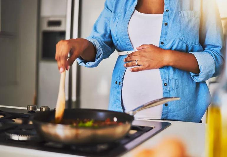 pregnant woman cooking